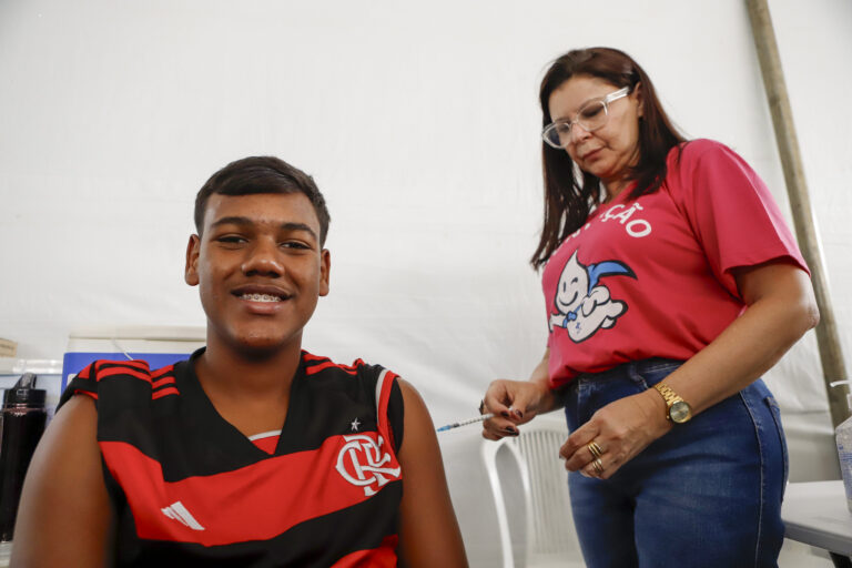 Adolescente sendo vacinado